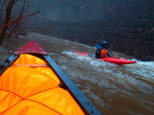 Surfin' by the rock wall.